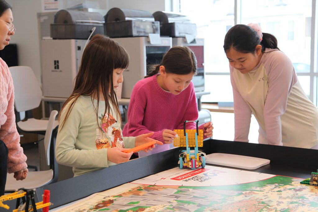Kids testing LEGO robots at Valley Robotics Club in Menasha Public Library.