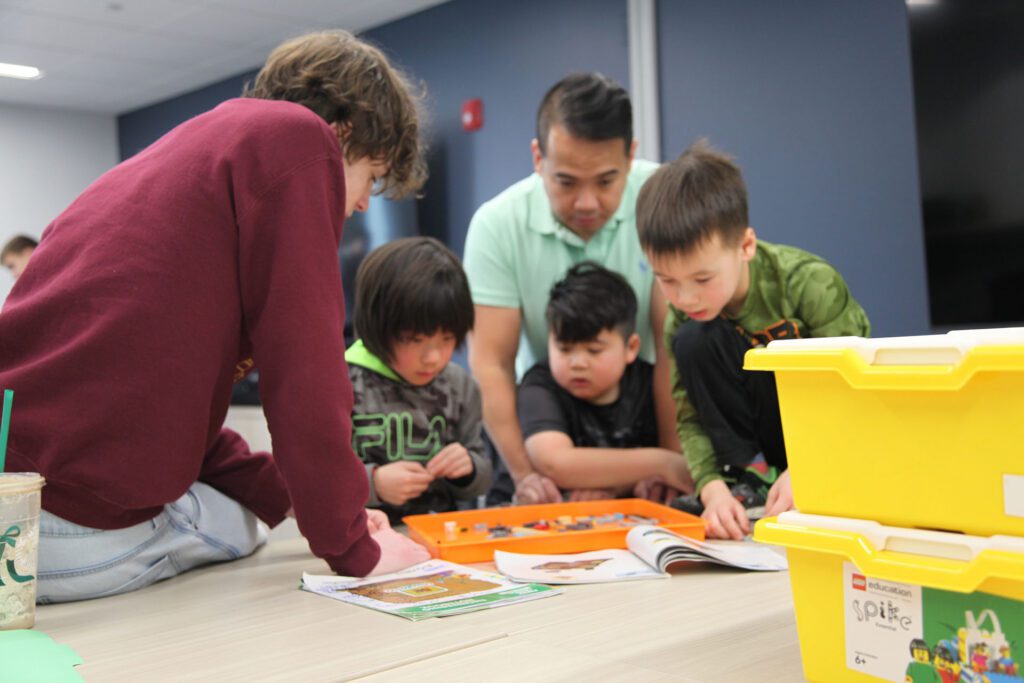 Explore team Kids building LEGO at Valley Robotics Club in Menasha Public Library.