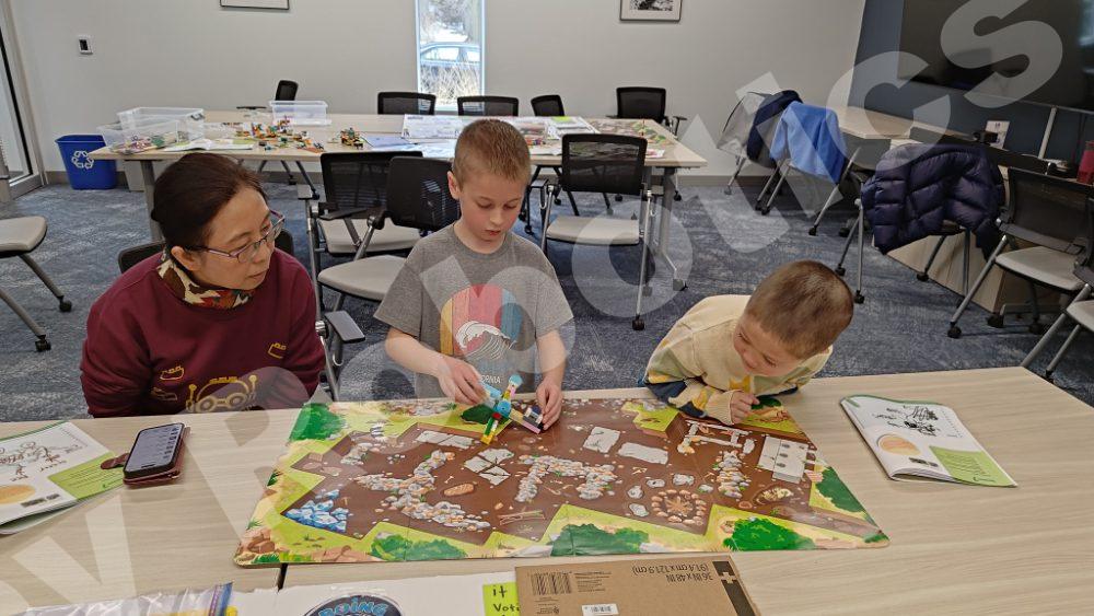 A teacher guiding kids as they build Lego models during a 2025 Fall Program class at Valley Robotics Club.
